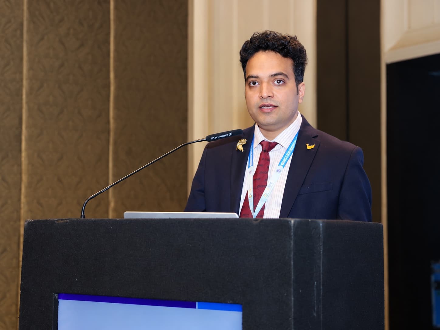 Dr. Radhamadhab Sahu delivering keynote presentation on minimally invasive skull base surgery at conference lectern